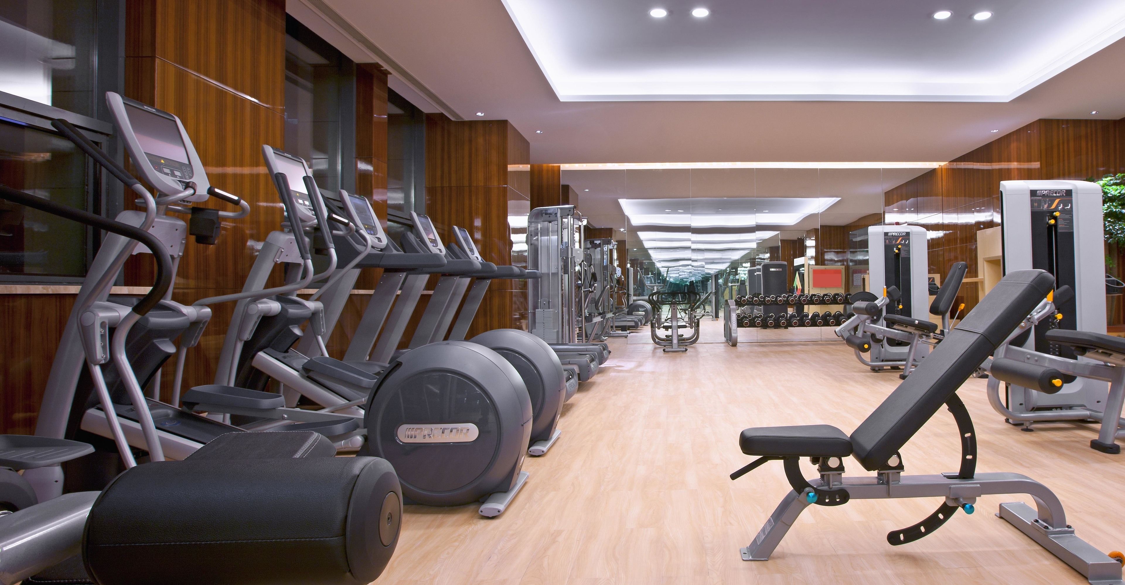 A gym with treadmills, elliptical machines, and weight machines.