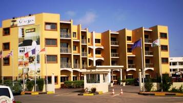 Stunning hotel building with a central entrance and balconies on each floor.