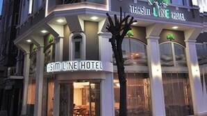 A modern hotel with a glass facade, a prominent sign reading "Taksim Line Hotel," and a well-lit entrance. - Taksim Line Hotel (Istanbul)