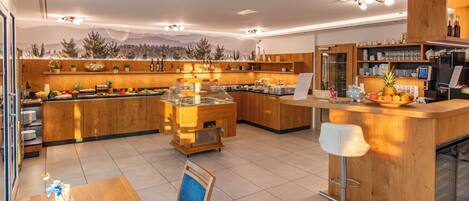 A modern kitchen with wooden cabinets, a central island, and a bar area.
