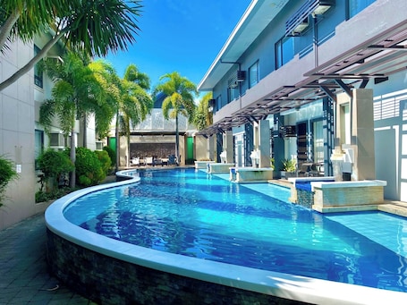 Outdoor pool, pool loungers. Circle Inn - Hotel & Suites