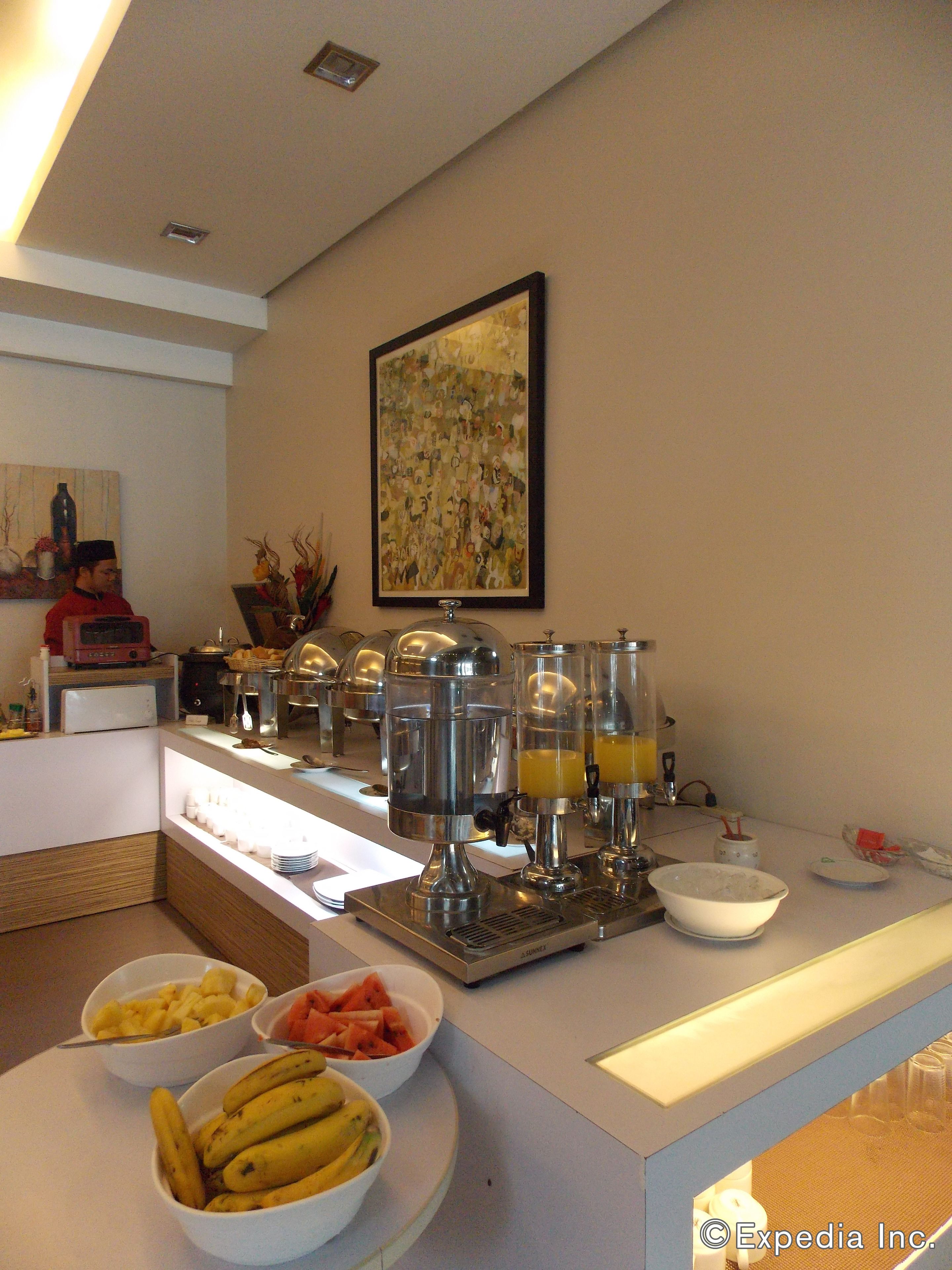 A breakfast buffet with various food items and juice dispensers.