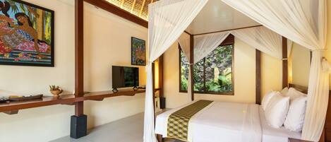 A bedroom with a four-poster bed, a television, and artwork on the walls.