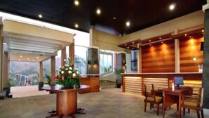 A spacious lobby with a reception desk, seating area, and a view of the outdoors. - Marbella Suites Bandung (Bandung)