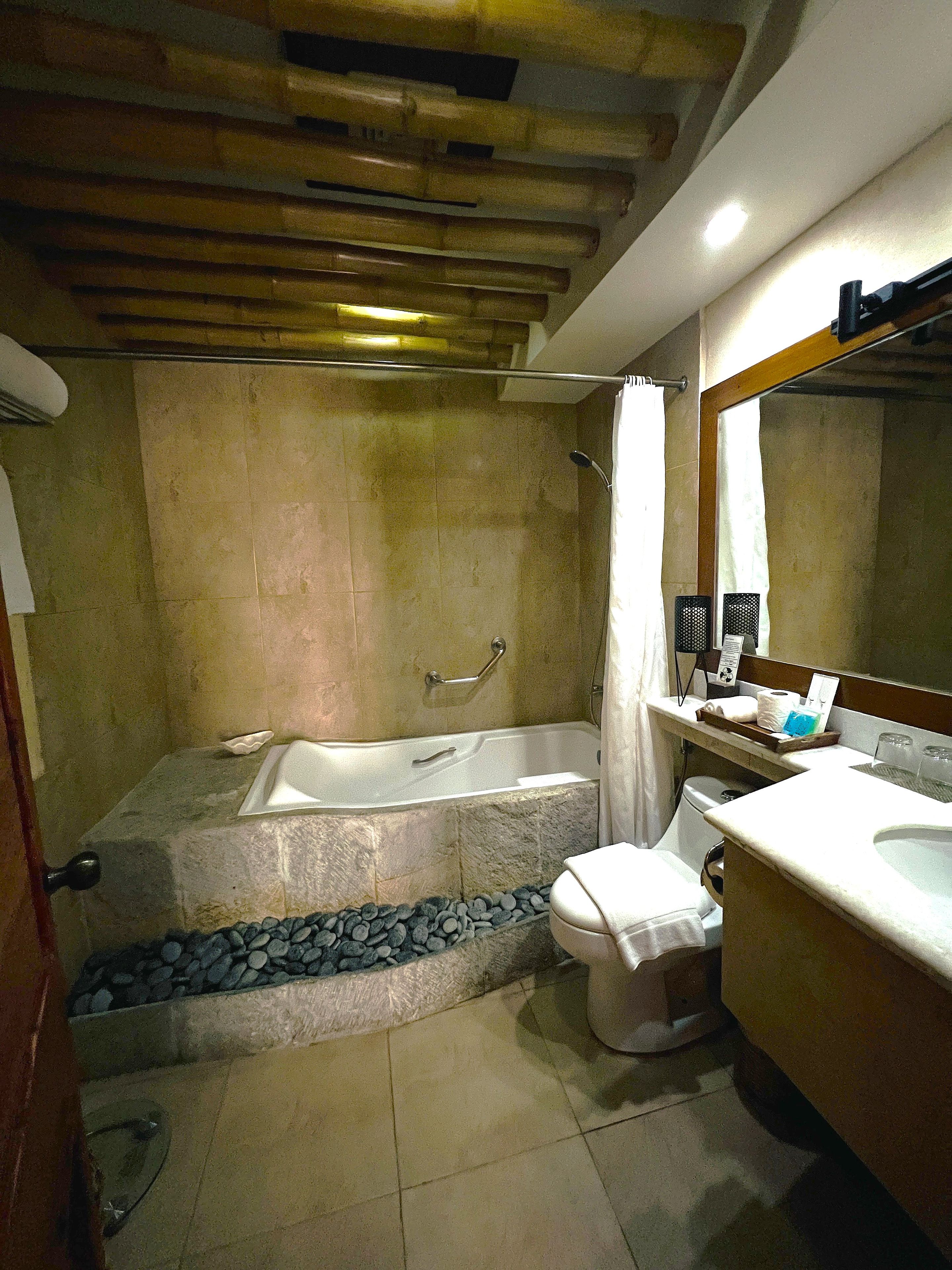 A bathroom with a bathtub, toilet, and sink.