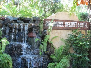 A sign for Rio Grande Resort Hotel with a waterfall feature. - Rio Grande de Laoag Resort Hotel (Laoag)