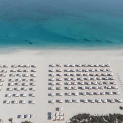 On the beach, white sand, sun loungers, beach umbrellas