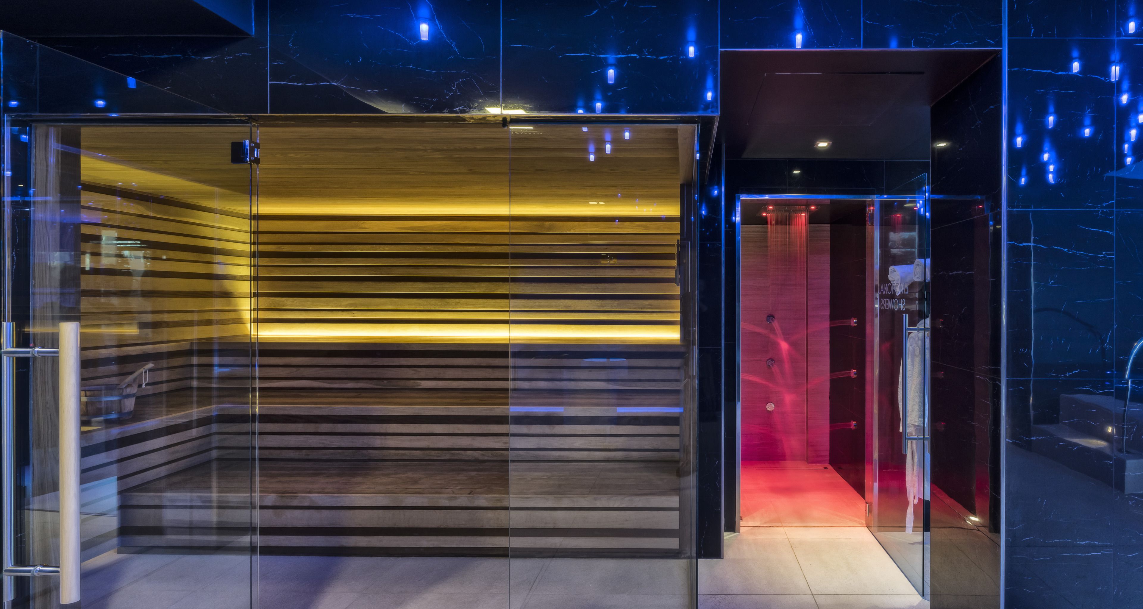 A modern elevator with a glass enclosure and a wooden interior.