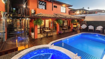 Una piscina al aire libre, sillones reclinables de piscina