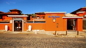A building with the sign 'POUSADA EL Parador' and 'EL Parador' on the entrance. - Pousada El Parador (Búzios)