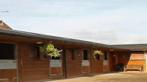 A stable with multiple stalls, each with a door and a window. - The Old Dairy Farm (Emsworth)