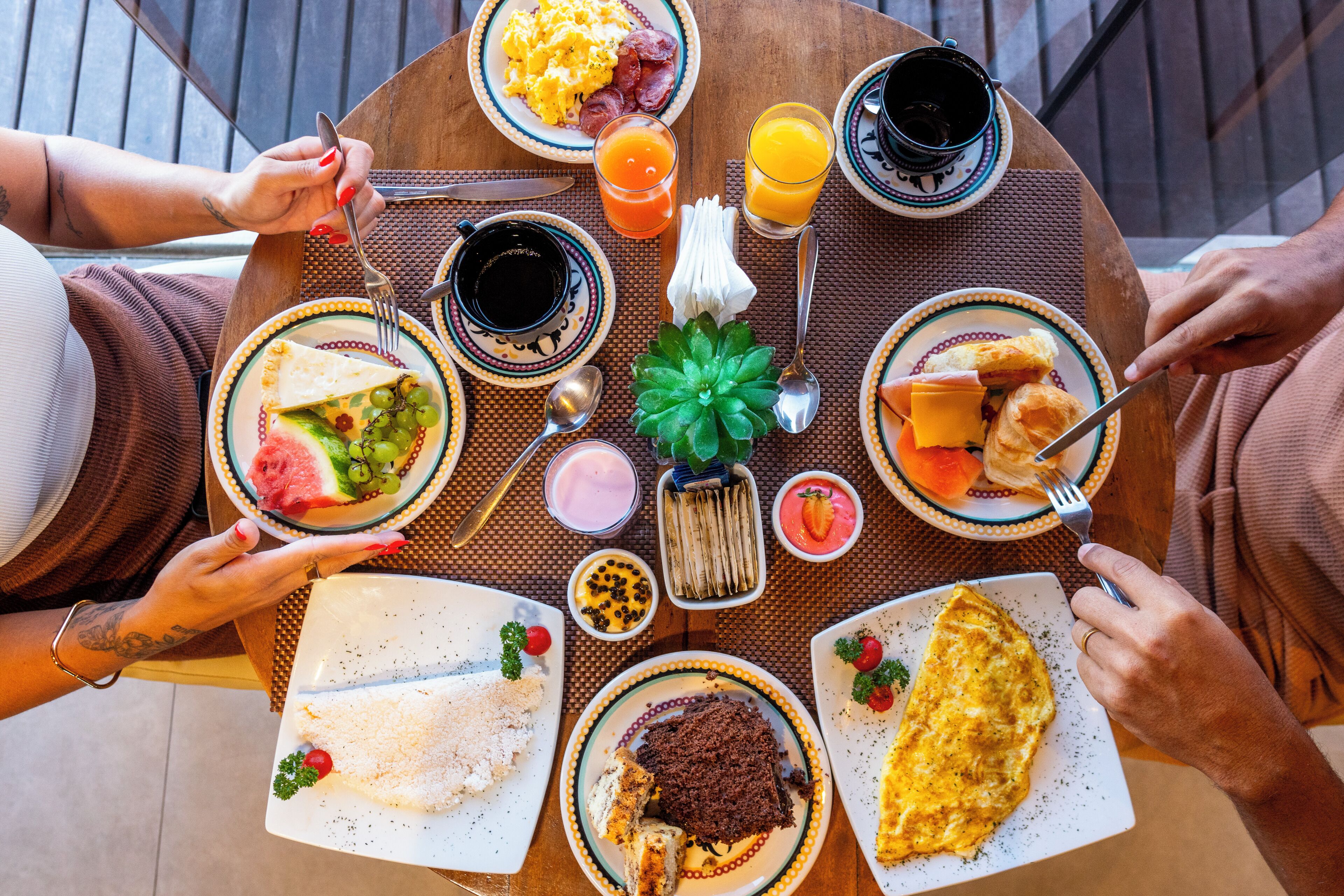 A round table with breakfast items including eggs, toast, and a variety of spreads.