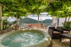 A hot tub area with a view of a mountain and a building in the background.