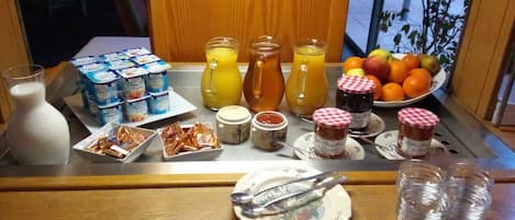 A breakfast buffet with various food items and beverages.