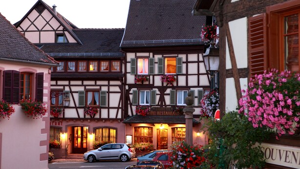 A traditional European hotel with a classic half-timbered facade, multiple windows, and a welcoming entrance. - A la Vignette (Saint-Hippolyte)