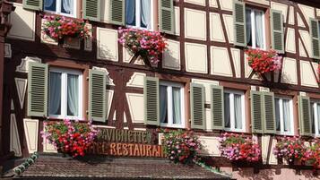 A traditional half-timbered building with a sign for a restaurant.