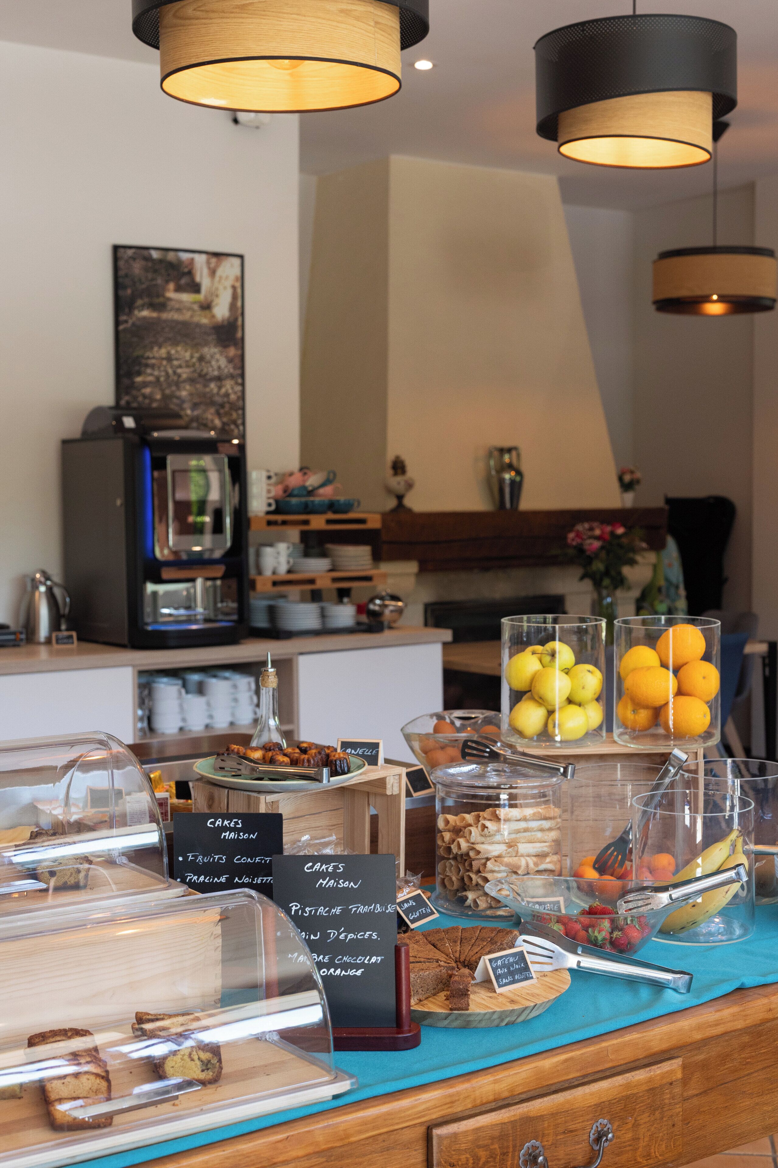 A breakfast buffet with various food items, a coffee machine, and a coffee urn.