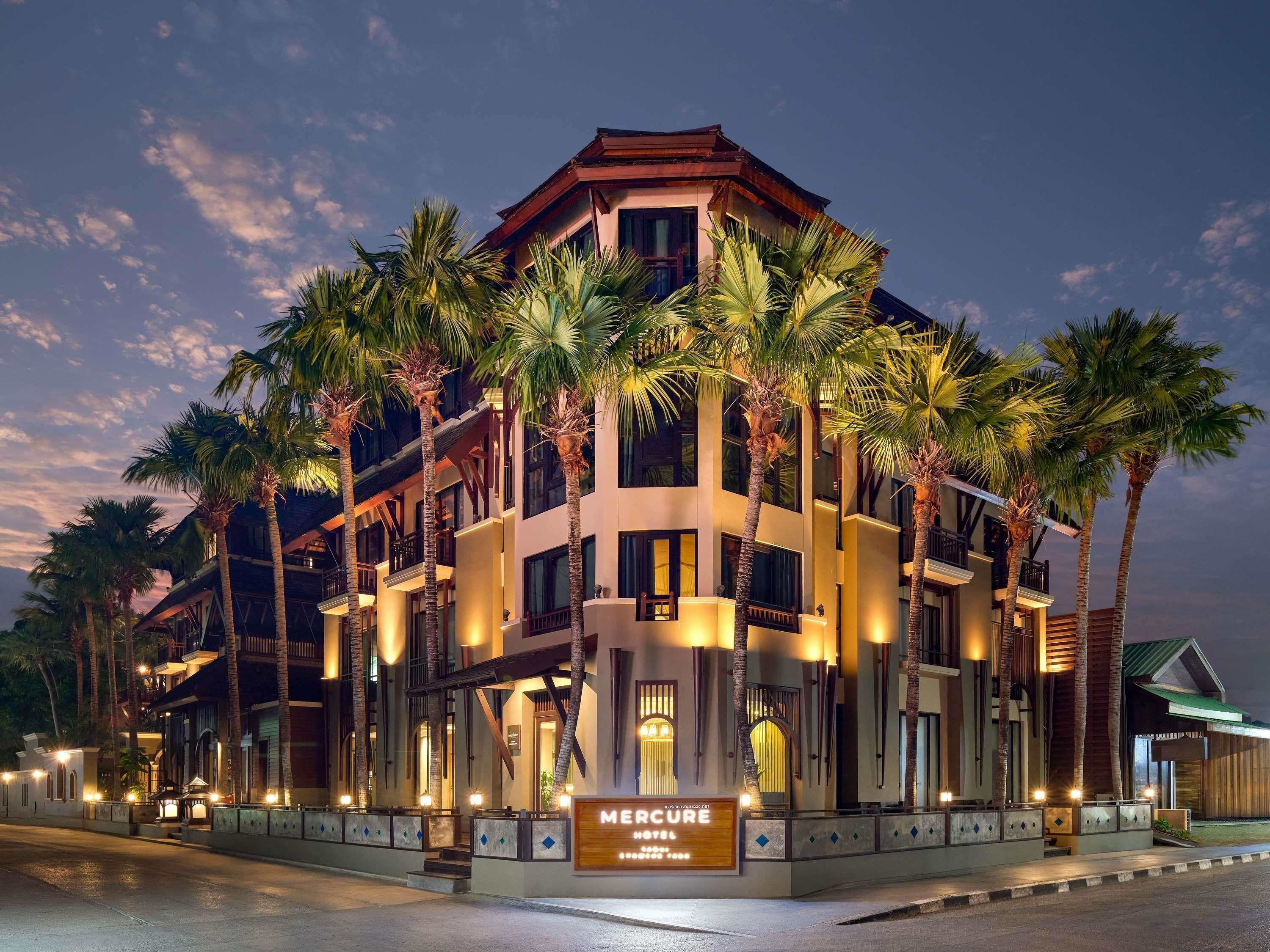 A multi-story hotel with a sign reading 'Mercure Hotel.'