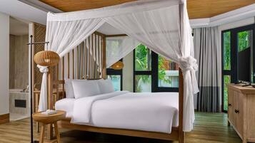 A bedroom with a canopy bed, a bedside table, a lamp, and a view of greenery outside.