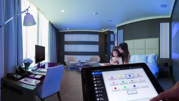 Relax in a spacious room with a large bed, desk, and wall-mounted TV.