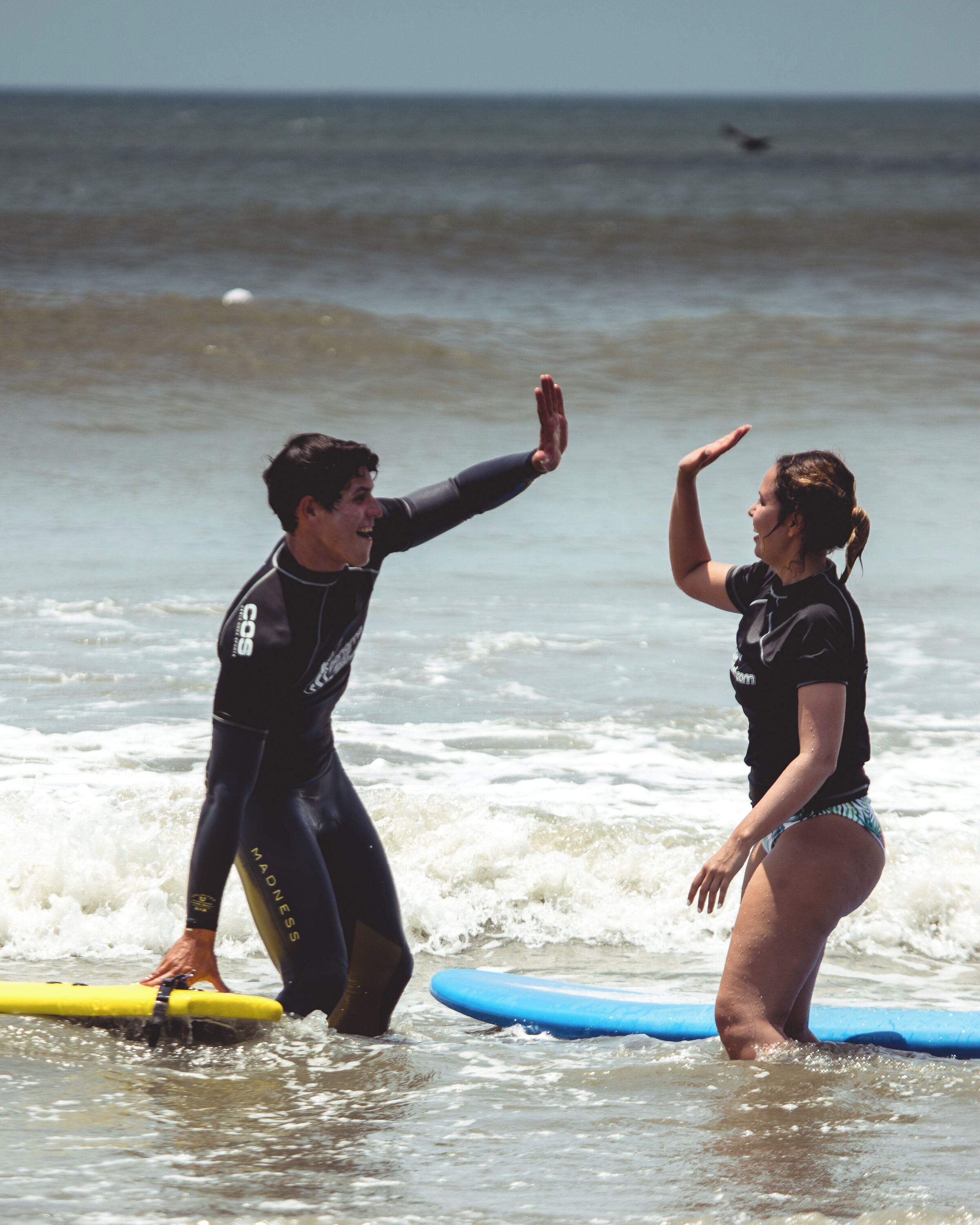Two people on surfboards in the ocean.