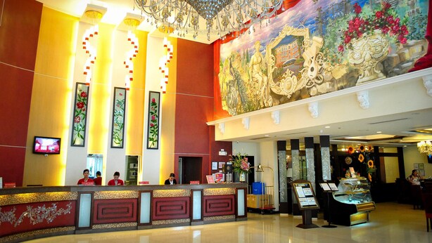 A hotel lobby with a reception desk, a chandelier, and a large mural on the wall. - Hotel Elizabeth Cebu (Cebu City)