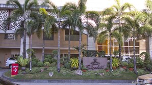 A hotel entrance with a sign reading "HOTEL Elizabeth." There are palm trees and a well-maintained garden in front. - Hotel Elizabeth Cebu (Cebu City)
