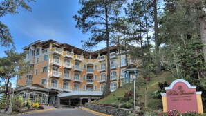 A multi-story hotel with balconies, a landscaped entrance, and a sign indicating the name 'Hotel Elizabeth'. - Hotel Elizabeth Baguio (Baguio)