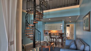 A spacious living area with a spiral staircase, a dining area, and a kitchen. - Hotel Elizabeth Baguio (Baguio)