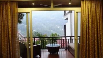 A balcony with a view of a mountainous landscape.