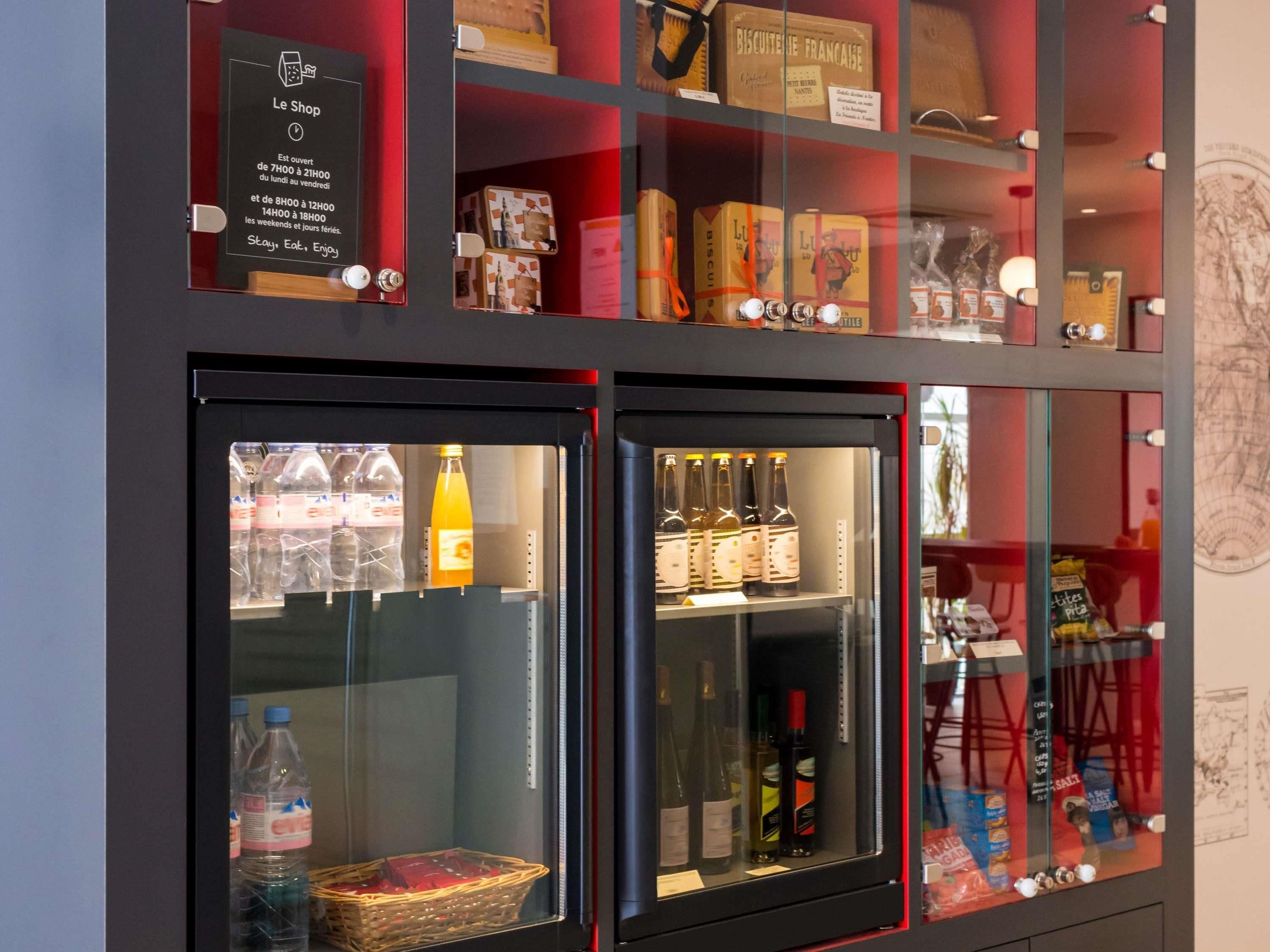 A display case with various food items and beverages, including bottles and boxes.