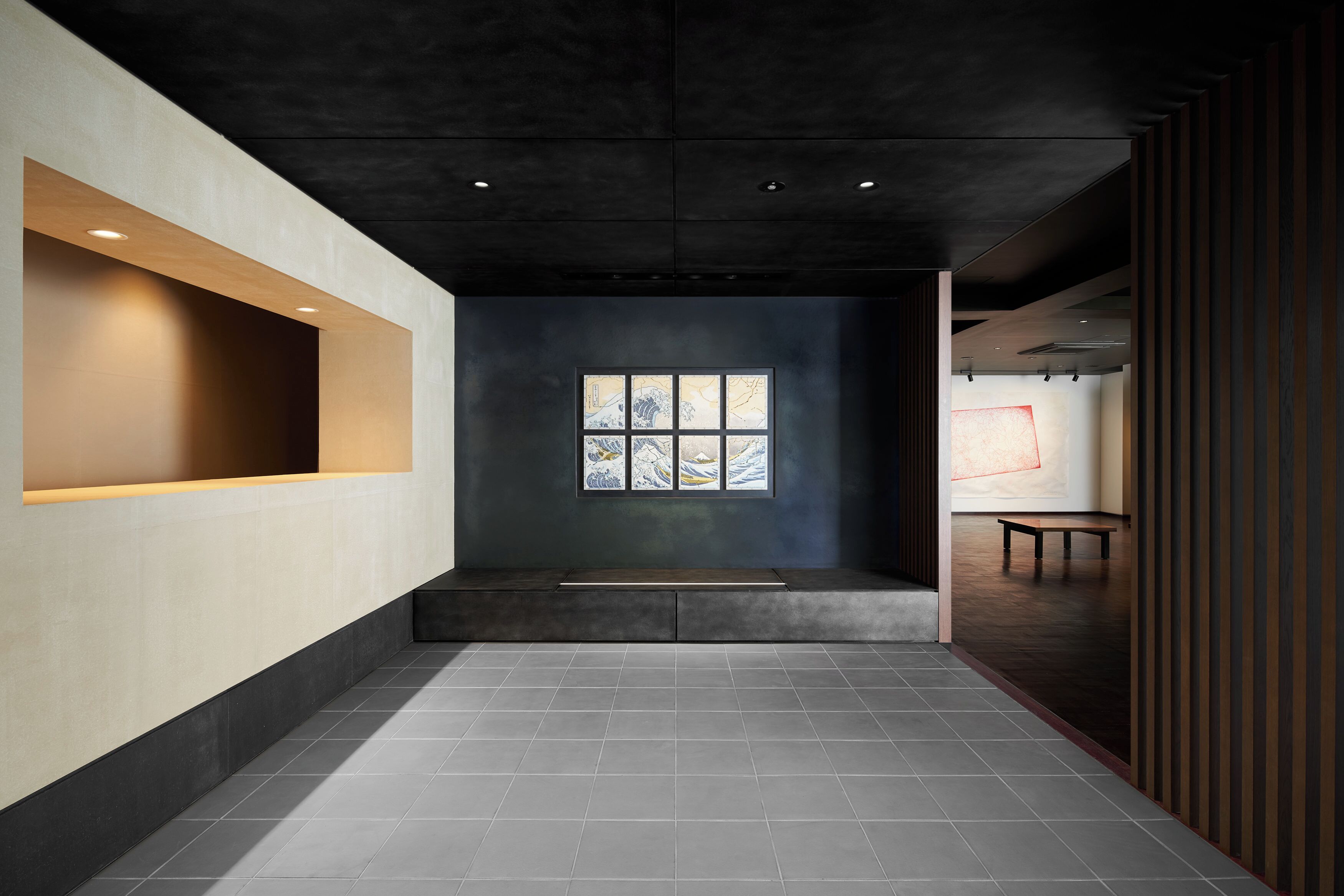 A modern interior with a recessed ceiling, a large window with a view, and a bench.