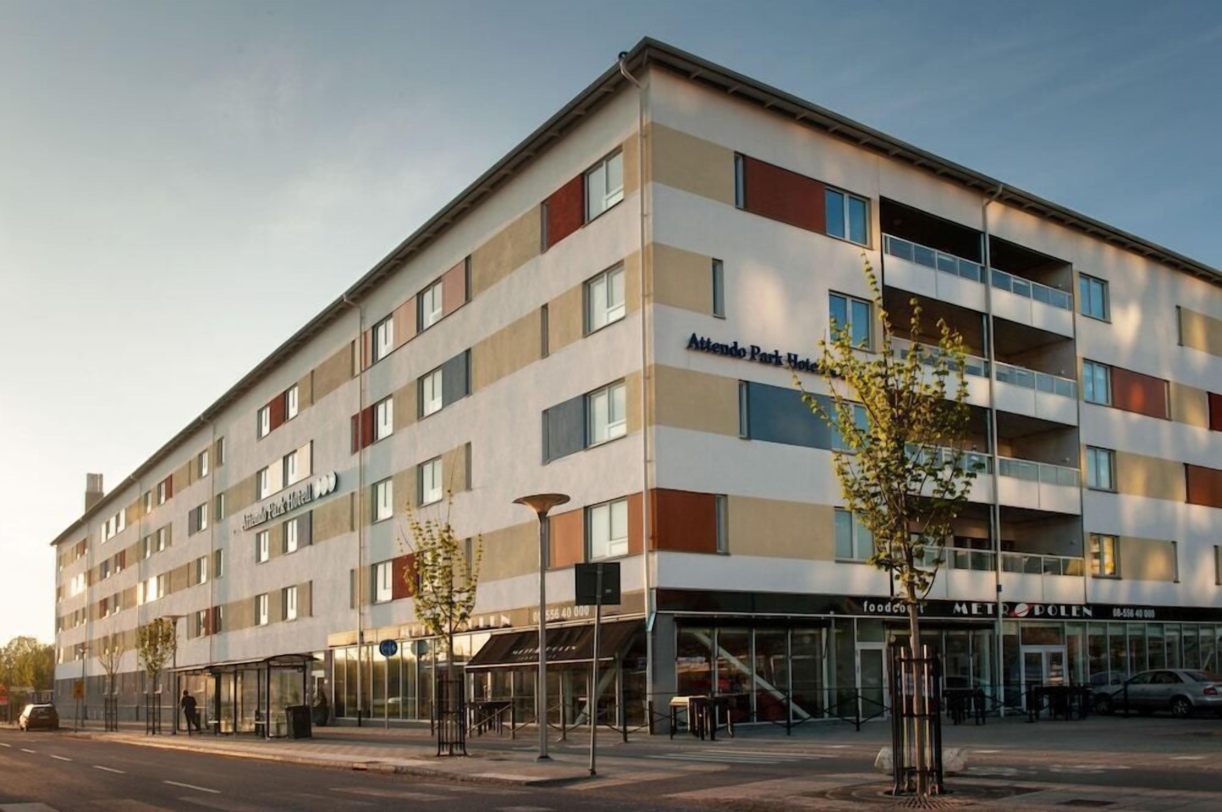 A multi-story hotel with a modern design, featuring a ground-level restaurant and a visible entrance.
