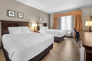 A hotel room with two beds, a desk, a chair, and a window with curtains. - Country Inn & Suites by Radisson, Port Orange-Daytona, FL (Port Orange)