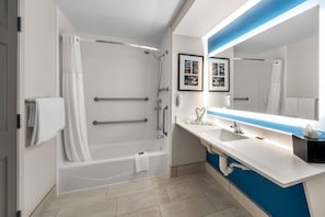 A modern bathroom with a bathtub, a shower, a sink, and a mirror. - Country Inn & Suites by Radisson, Port Orange-Daytona, FL (Port Orange)