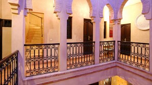A building with multiple arches and balconies with wrought iron railings. - Riad Marrakiss (Marrakech)