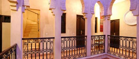 A building with multiple arches and balconies with wrought iron railings.