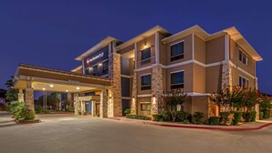 A multi-story hotel with a covered entrance and a sign reading "Best Western PLUS". - Best Western Plus Lytle Inn & Suites (Lytle)