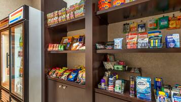 A hotel minibar with snacks, beverages, and toiletries.
