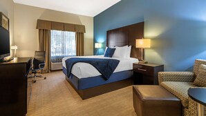 A hotel room with a large bed, a desk, a chair, and a TV. - Best Western Plus Lytle Inn & Suites (Lytle)