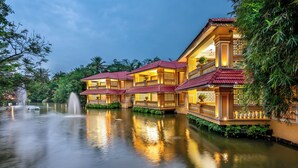 A traditional building with multiple balconies and a water feature in front. - Mayfair Lagoon (Bhubaneshwar)