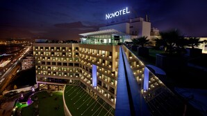 A Novotel hotel with a modern design, featuring multiple floors and a well-lit facade. - Novotel Visakhapatnam Varun Beach Hotel (Visakhapatnam)