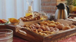 A breakfast buffet with pastries, fruits, and a coffee pot. - Locanda Canareggio (San Biagio di Callalta)