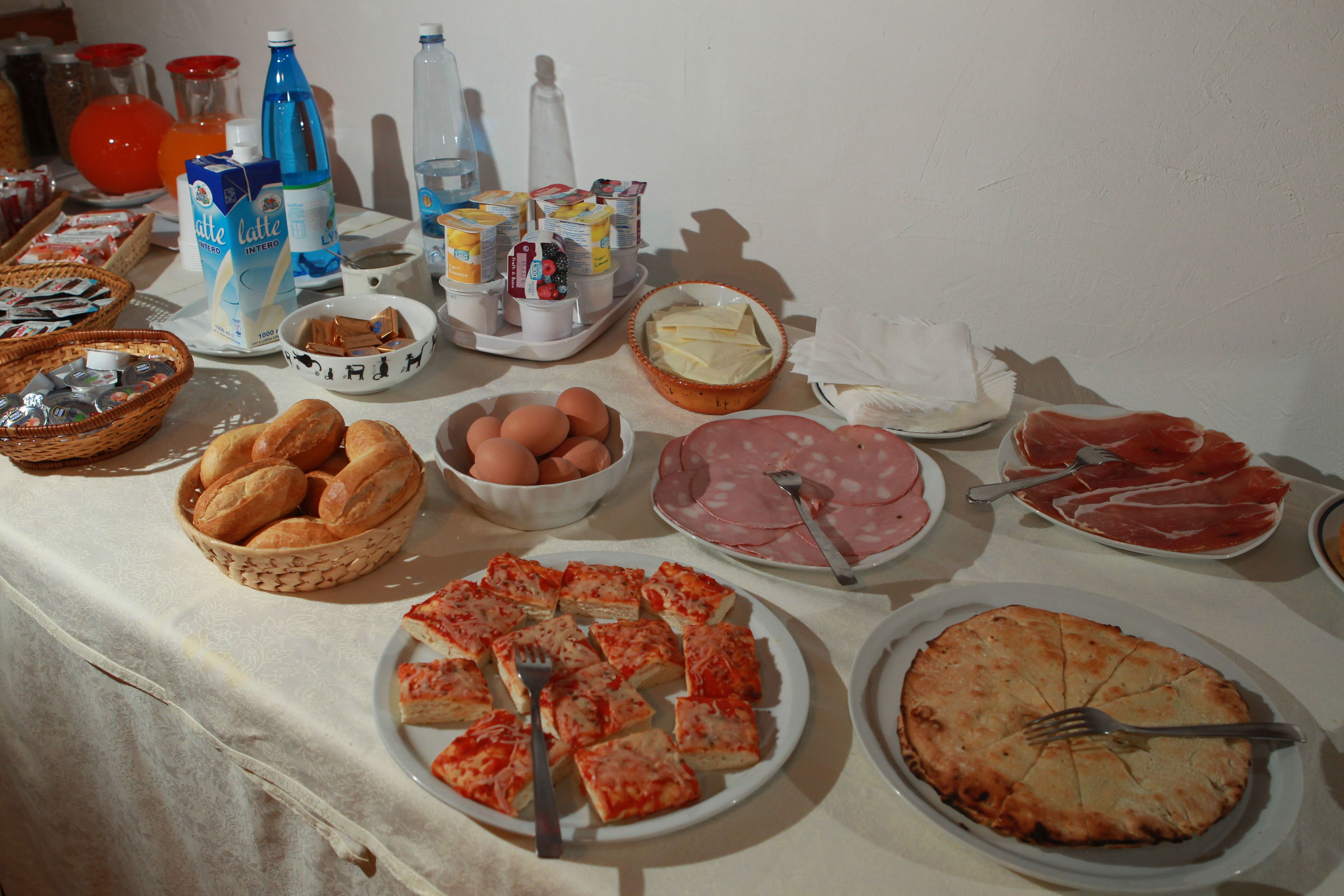 A buffet table with various food items and beverages.