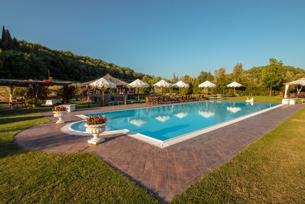 Seasonal outdoor pool, open 9:00 AM to 7:00 PM, pool umbrellas