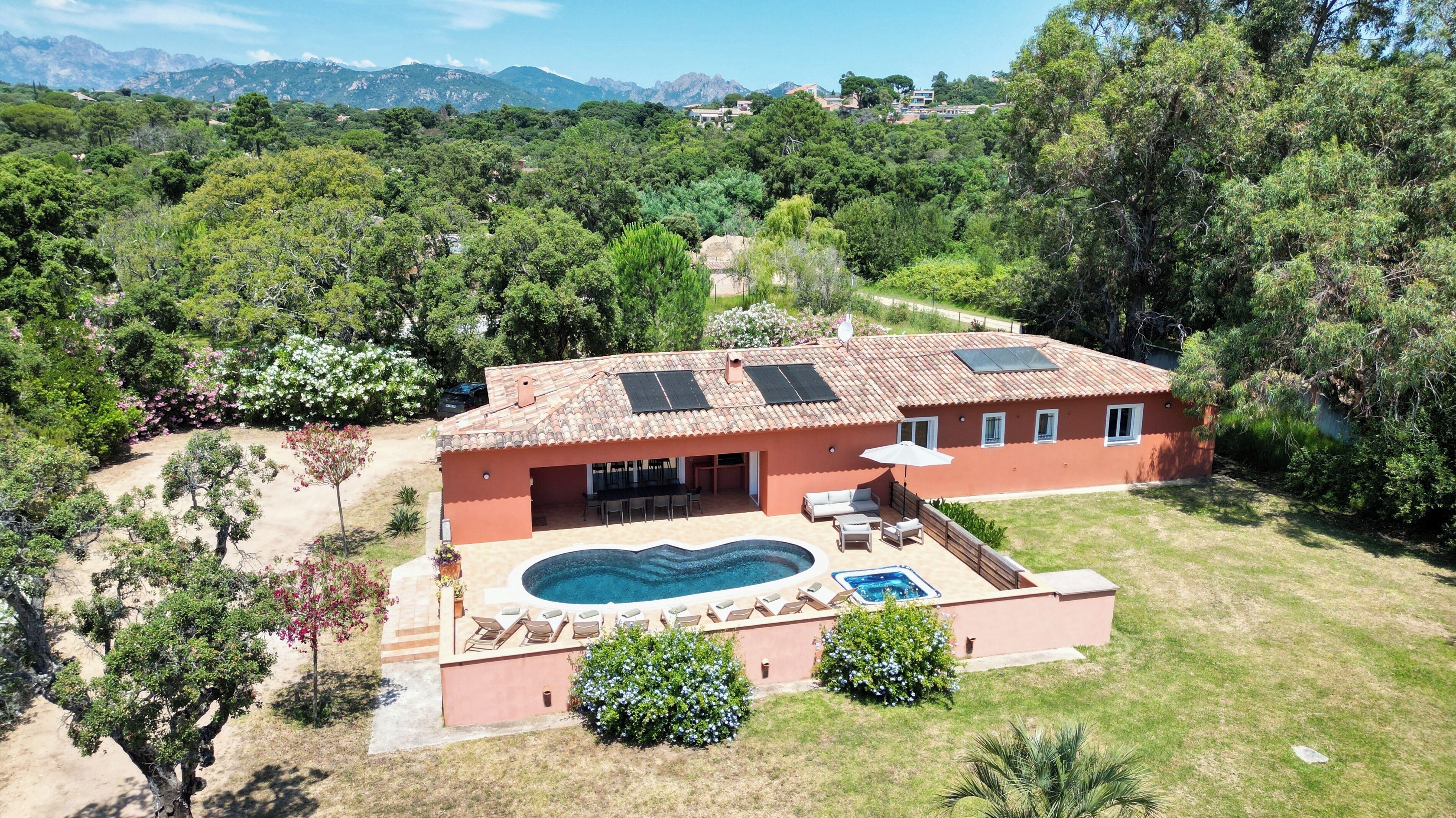 A house with a swimming pool, patio, and a view of mountains.