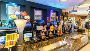 A bar area with multiple beer taps, a large beer mug, and various bottles. - The Littleover Lodge Hotel (Derby)