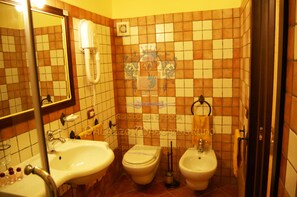 A bathroom with two sinks, a toilet, and a bidet. - Palazzo Mascambruno (Cariati)