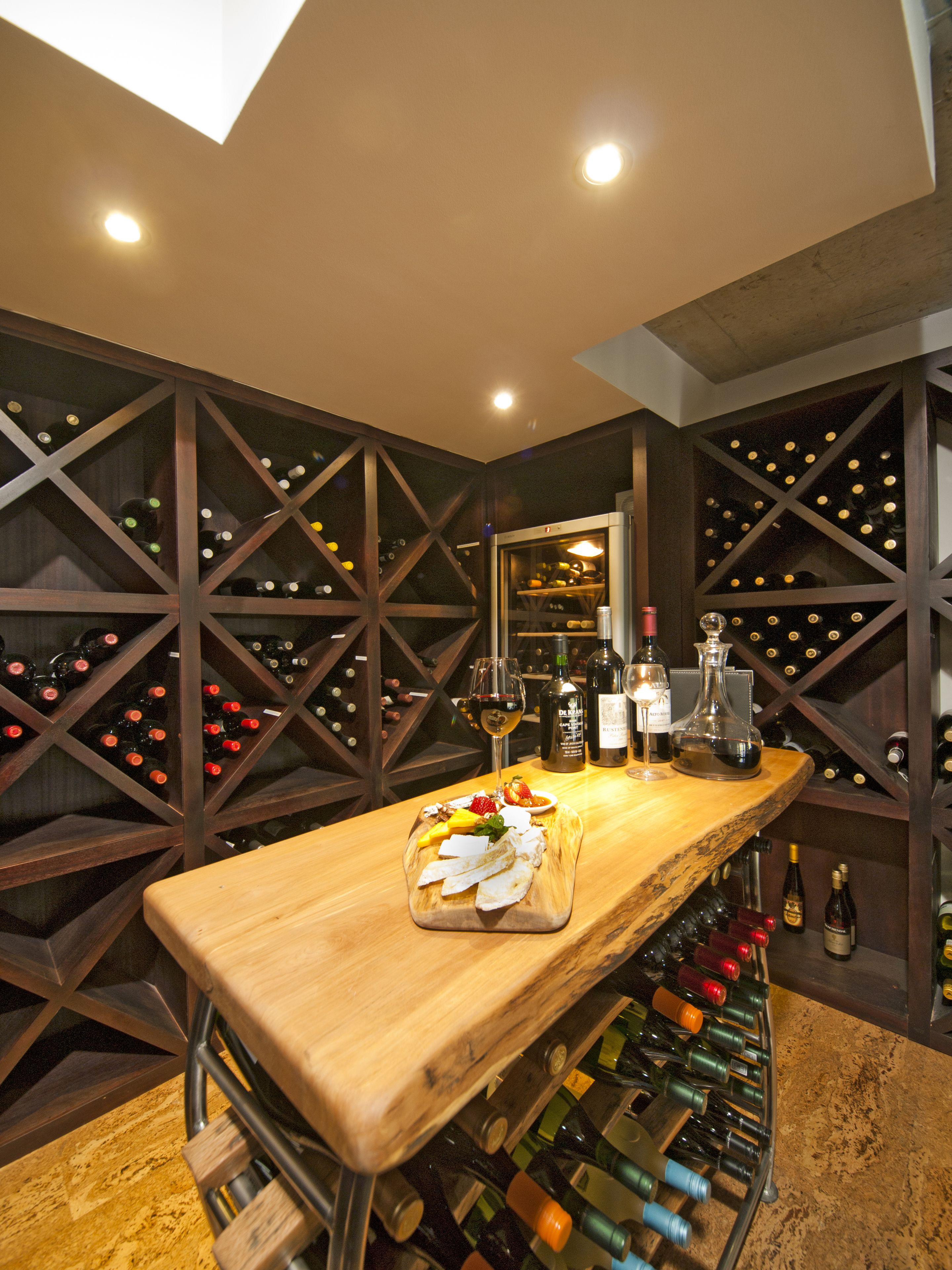 A wine cellar with a wooden bar and wine racks.