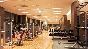 A gym with various exercise equipment, including treadmills, weight machines, and dumbbells. - Stanford Hotel Seoul (Seoul)